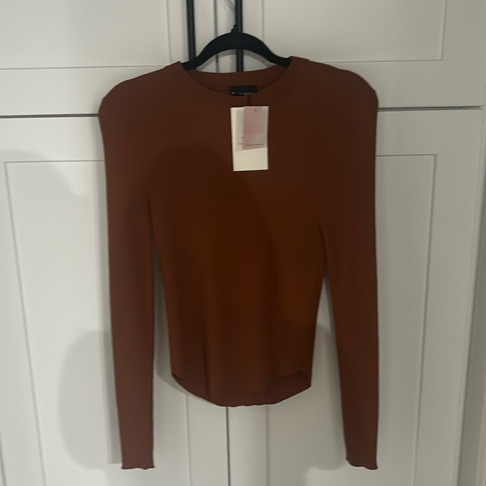 nice shirt with tags bought from a boutique brand is Miou Muse size medium